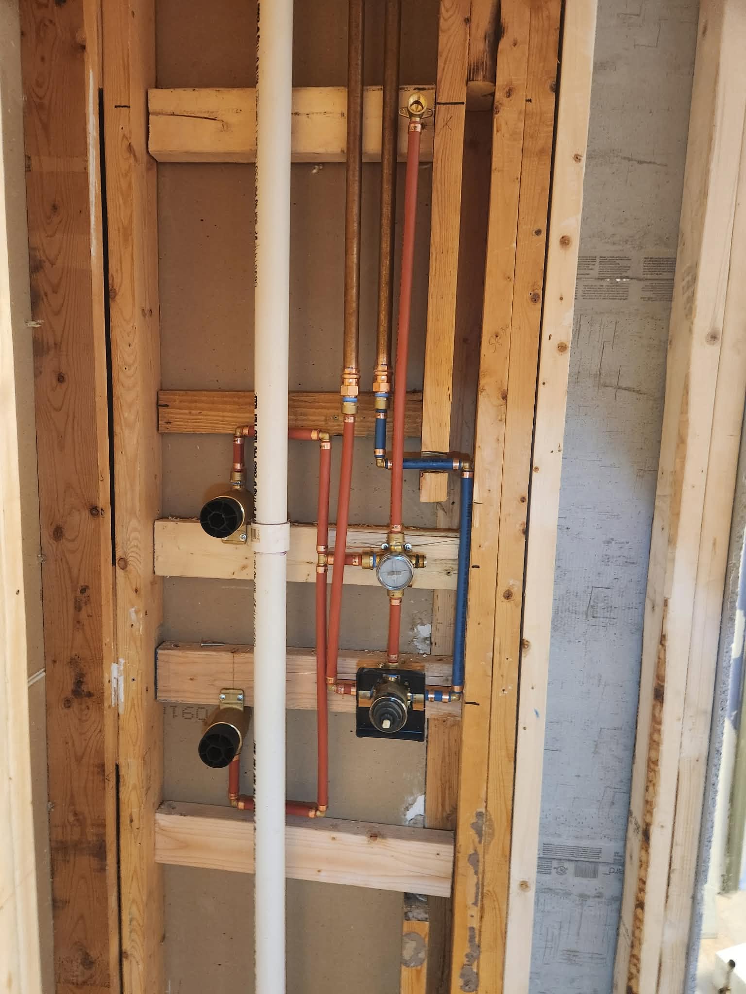 Rough-in plumbing valves inside wall framing