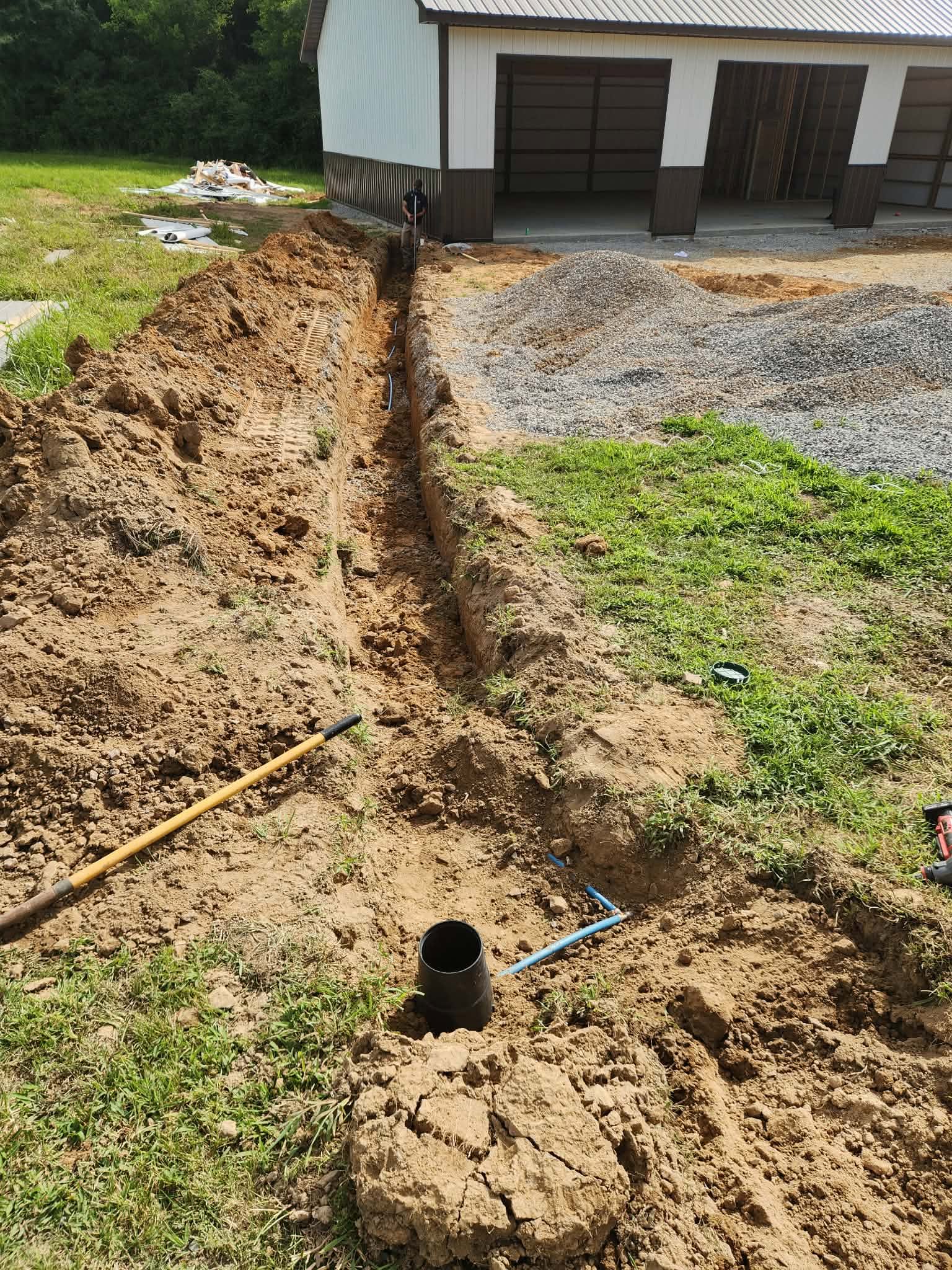 Sewer line trench run to a new pole barn